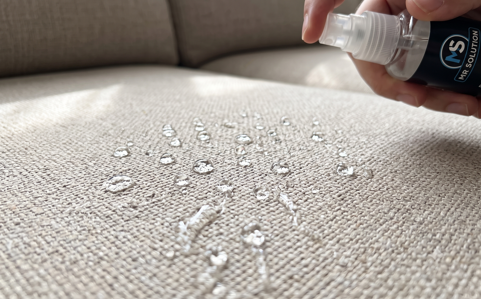 Water droplets beading on protected sofa fabric
